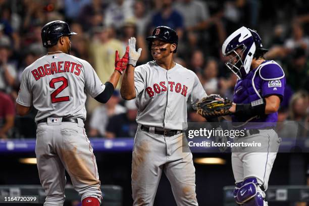 Boston Red Sox shortstop Xander Bogaerts is congratulated by third baseman Rafael Devers after hitting a fifth inning two-run home run against the...
