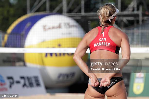 Heather Bansley of Canada signals her teammate Brandie Wilkerson in the Women’s bronze medal match against Karla Borger and Julia Sude of Germany on...