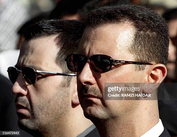 Picture dated June 13, 2003 shows Syrian President Bashar al-Assad and his brother Maher attending their father's funeral in Damascus on June 13,...