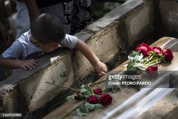 Boy attends the funeral of a victim of the attack at the Caballo Blanco bar , during the funeral at a cemetery in Coatzacoalcos, Veracruz State,...