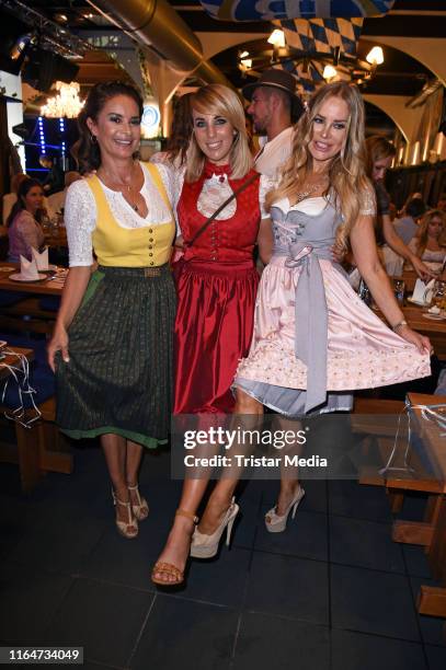 Gitta Saxx, Annemarie Eilfeld and Xenia Seeberg attend the Angermaier Trachtennacht at Hofbraeu Wirtshaus on August 29, 2019 in Berlin, Germany.