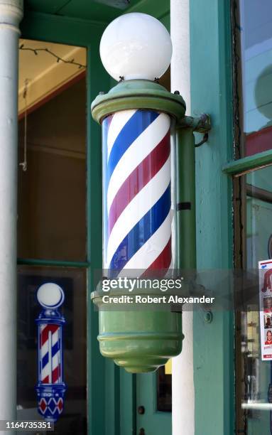 Classic red, white and blue barber's pole identifies a barber shop in Jacksonville, Oregon, near Medford.