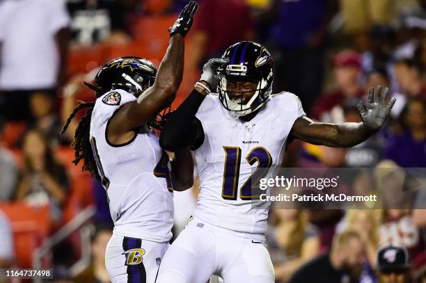 Jaleel Scott of the Baltimore Ravens celebrates with teammate De'Lance Turner of the Baltimore Ravens after scoring a touchdown in the second quarter...