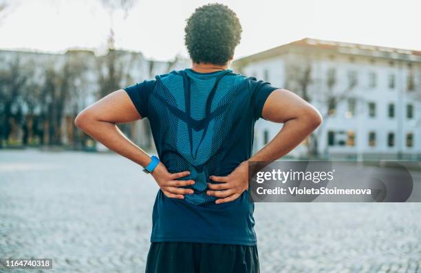 back pain. sport injury. - coluna vertebral humana imagens e fotografias de stock