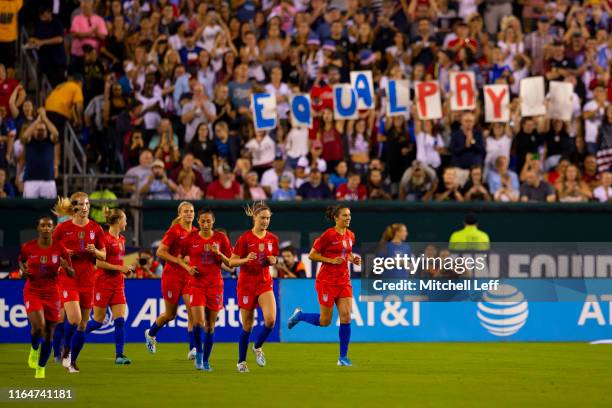 Crystal Dunn, Sam Mewis, Emily Sonnett, Lindsey Horan, Christen Press, Morgan Brian, and Carli Lloyd of the United States make their way to midfield...