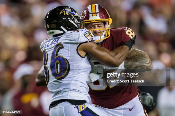 Nick Boyle of the Baltimore Ravens tackles J.P. Holtz of the Washington Redskins during the first half of a preseason game at FedExField on August...