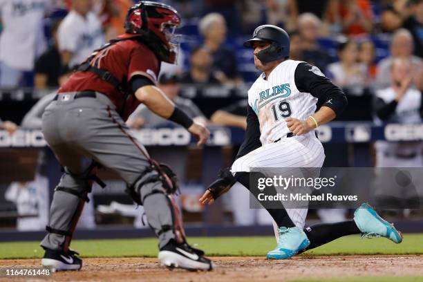 Miguel Rojas of the Miami Marlins scores a run in the fifth inning against the Arizona Diamondbacks at Marlins Park on July 28, 2019 in Miami,...