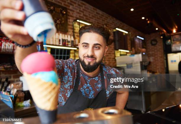 man preparing ice cream in ice cream parlor - ice cream shop stock pictures, royalty-free photos & images