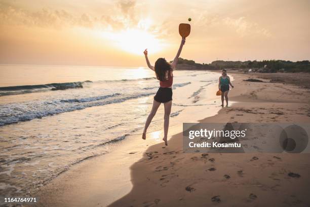 best friends having fun on summer vacation - paddle ball stock pictures, royalty-free photos & images