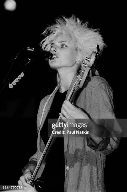 American Rock and Pop musician Aimee Mann, of the group 'Til Tuesday, plays bass guitar as she performs on stage at the Poplar Creek Music Theater,...