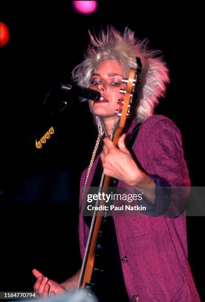 American Rock and Pop musician Aimee Mann, of the group 'Til Tuesday, plays bass guitar as she performs on stage at the Poplar Creek Music Theater,...