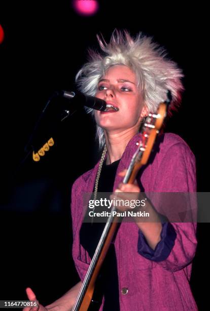 American Rock and Pop musician Aimee Mann, of the group 'Til Tuesday, plays bass guitar as she performs on stage at the Poplar Creek Music Theater,...