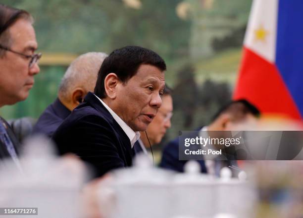 Philippine President Rodrigo Duterte speaks to Chinese Premier Li Keqiang during their meeting at the Great Hall of the People on August 30, 2019 in...