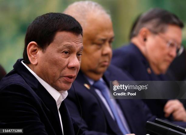 Philippine President Rodrigo Duterte speaks to Chinese Premier Li Keqiang during their meeting at the Great Hall of the People on August 30, 2019 in...