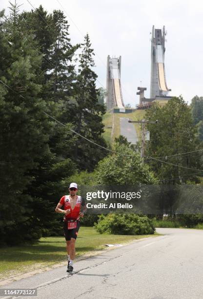 Christopher Reibel runs past the ski jump used in the 1980 Winter Olympics during the Ironman triathlon on July 28, 2019 in Lake Placid, New York.