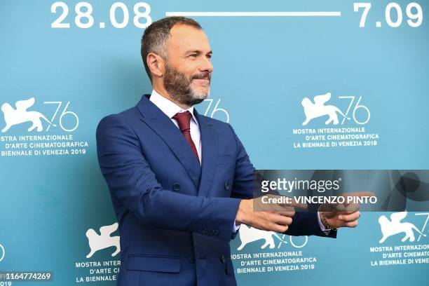 Italian actor Massimiliano Gallo gestures during a photocall for the film "Il Sindaco del Rione Sanita" presented in competition on August 30, 2019...