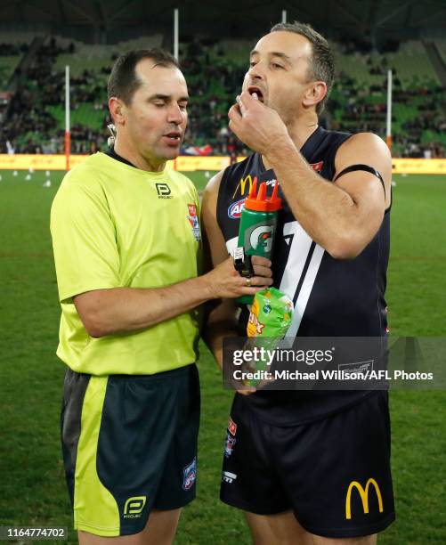 Ben Dixon of Victoria eats some lollies from the umpire during the 2019 EJ Whitten Legends Game between Victoria and the All Stars at AAMI Park on...