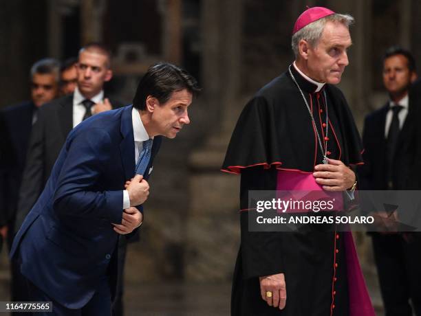 Italys Prime Minister Giuseppe Conte , escorted by a Prefect of the Papal household, Georg Gaenswein arrives to attend a Pope's funeral mass for late...