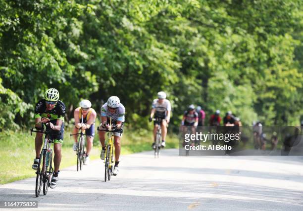 Competitors ride the bike portion of the Ironman triathlon on July 28, 2019 in Lake Placid, New York.