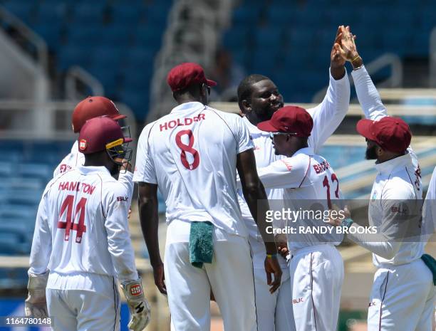 Rahkeem Cornwall of West Indies celebrates the dismissal of Cheteshwar Pujara of India during day 1 of the 2nd Test between West Indies and India at...