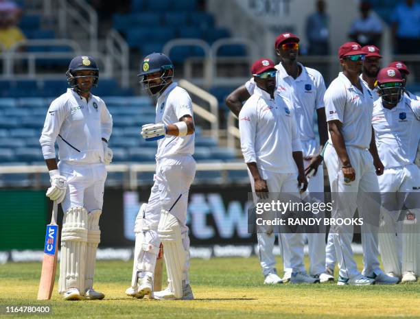Mayank Agarwal and Virat Kohli of India wait for an lbw review during day 1 of the 2nd Test between West Indies and India at Sabina Park, Kingston,...