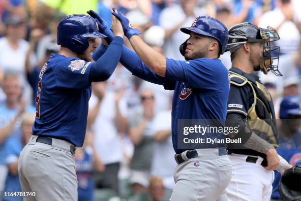 Ian Happ and Victor Caratini of the Chicago Cubs celebrate after Caratini hit a home run in the sixth inning against the Milwaukee Brewers at Miller...