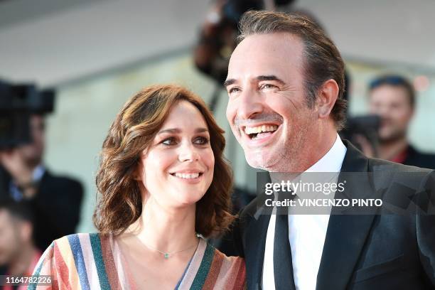 French actor Jean Dujardin and his wife French ice dancer Nathalie Pechalat arrive for the screening of the film "J'Accuse" presented in competition...