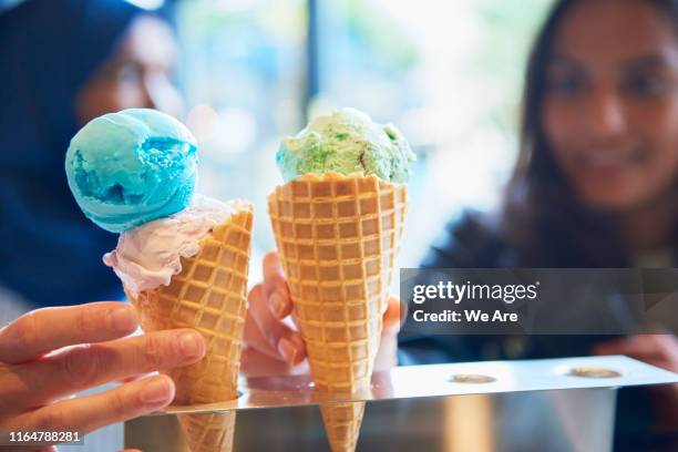 ice cream cones on a counter - ice cream counter stock-fotos und bilder