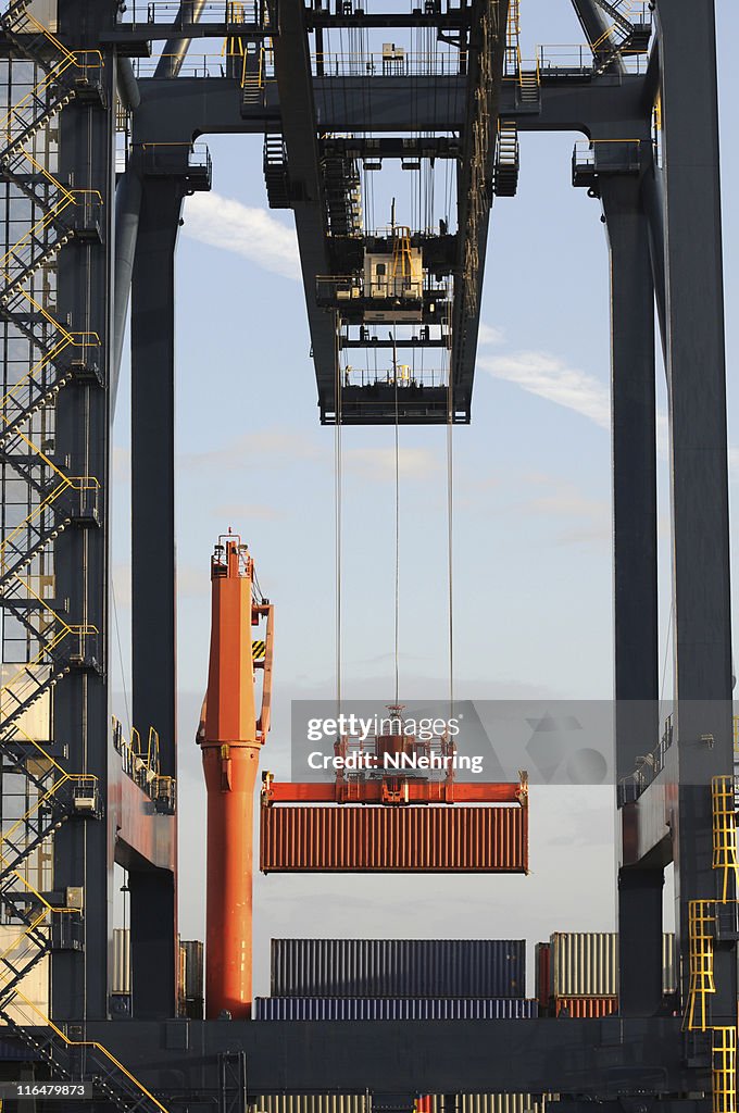 Dock crane loading container onto ship