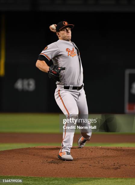 John Means of the Baltimore Orioles delivers a warm up pitch against the Arizona Diamondbacks at Chase Field on July 24, 2019 in Phoenix, Arizona.