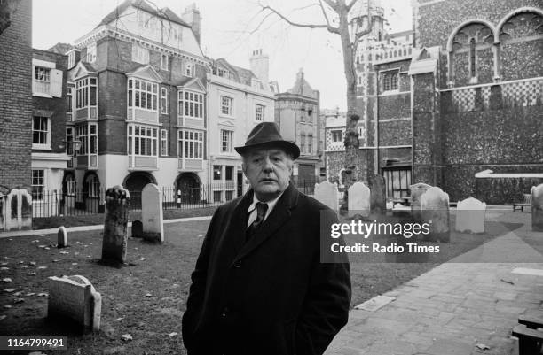 Poet Laureate John Betjeman in the churchyard of St Bartholomew the Great near his home, interviewed for the BBC television documentary 'Thank God...