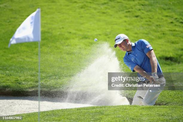 Tom Hoge of the United States chips from the bunker onto the 18th green during the final round of the Barracuda Championship at Montreux Country Club...