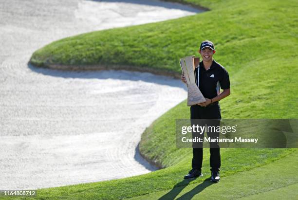 Collin Morikawa of the United States poses with the trophy after winning during the final round of the Barracuda Championship at Montreux Country...