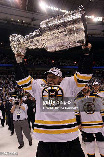 Dennis Seidenberg of the Boston Bruins celebrates with the Stanley Cup after defeating the Vancouver Canucks in Game Seven of the 2011 NHL Stanley...