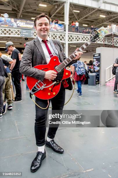 Cosplayer in character as Back to the Future 1. Marty McFly singing Johnny B Goode from the Prm scene in the film seen during London Film and Comic...