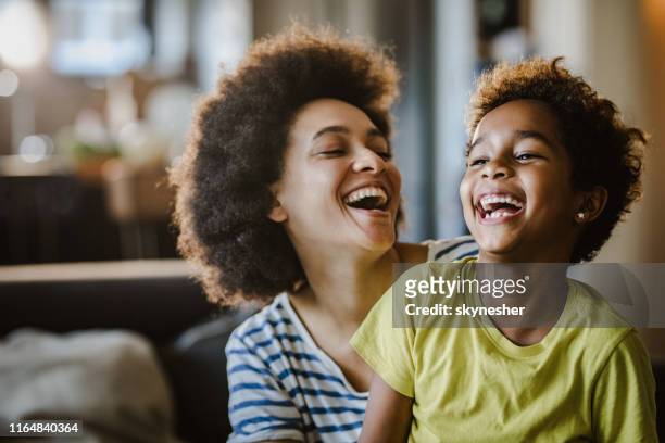 cheerful african american mother and daughter at home. - laughing family stock pictures, royalty-free photos & images
