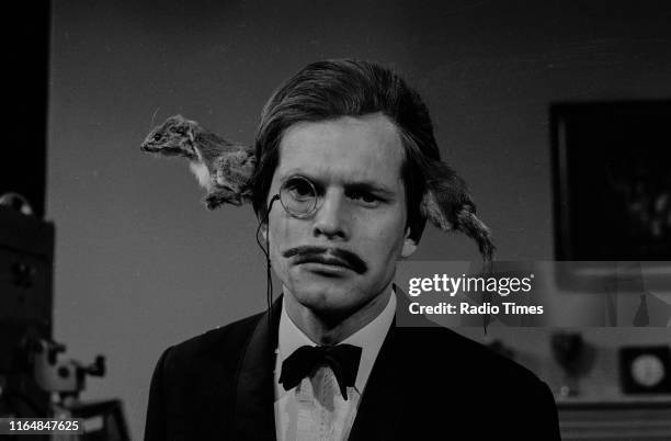 Comedian Terry Gilliam with a stoat on his head in the 'A Man with a Stoat Through his Head' sketch from series 2 of the BBC television series 'Monty...