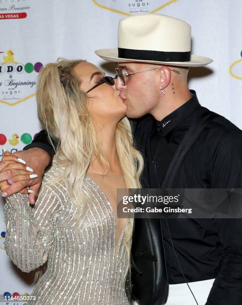 Tana Mongeau kisses Jake Paul during their wedding reception at the Sugar Factory American Brasserie at the Fashion Show mall on July 28, 2019 in Las...