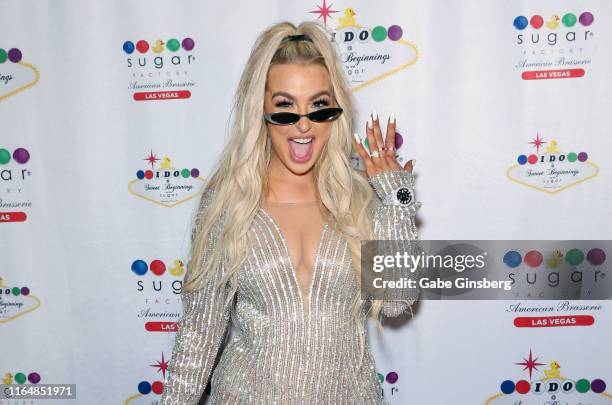 Tana Mongeau shows off her wedding ring during her wedding reception at the Sugar Factory American Brasserie at the Fashion Show mall on July 28,...