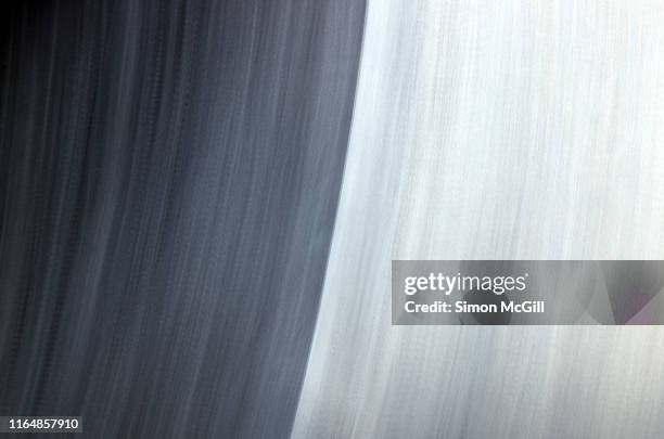 two burnished stainless steel surfaces with brushed texture - brushed steel background stock-fotos und bilder