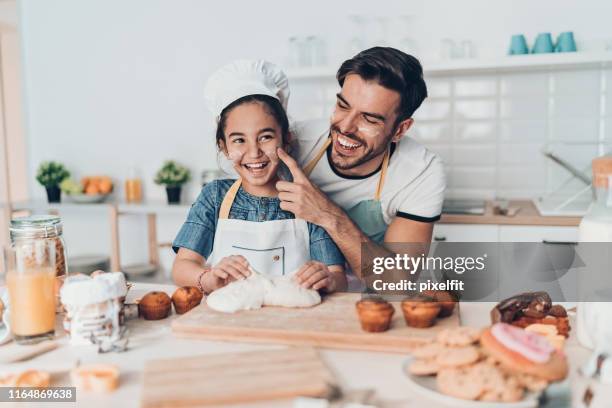 father and daughter playing in the kitchen - messy cake stock pictures, royalty-free photos & images