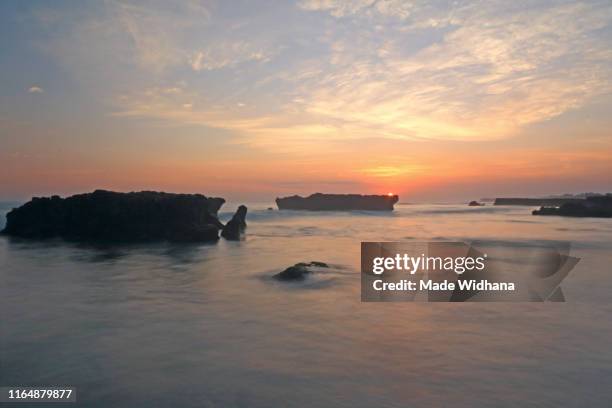 beach rocks and the sunset sky - made widhana stock pictures, royalty-free photos & images