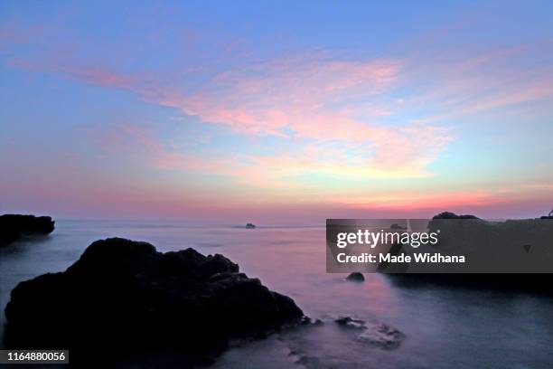 sunset long exposure at the beach - made widhana stock pictures, royalty-free photos & images