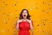 Pretty foxy lady surprised by unexpected birthday party arranging wear red dress isolated yellow background