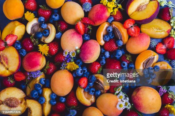 fresh summer colorful fruits and berries, top view - comida flores fotografías e imágenes de stock