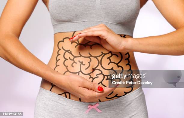 taking care of your intestines - woman hemorrhoids stock pictures, royalty-free photos & images