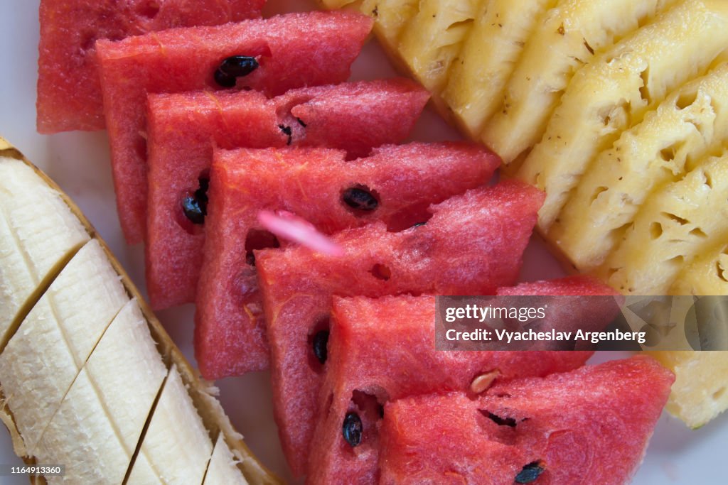 Slices of fresh watermelon, banana and pineapple