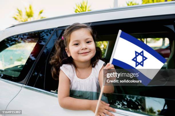 girl holding israel flag - israel people stock pictures, royalty-free photos & images