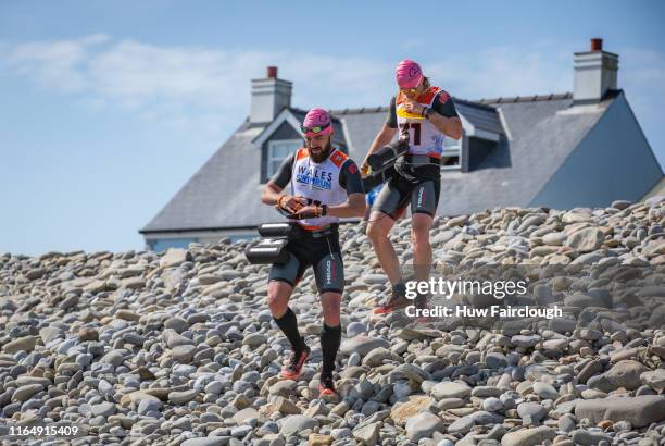 Alexis Charrier and Nicolas Remires prepare to enter the sea for their final swim during the Wales SwimRun race through Pembrokeshire, starting in...