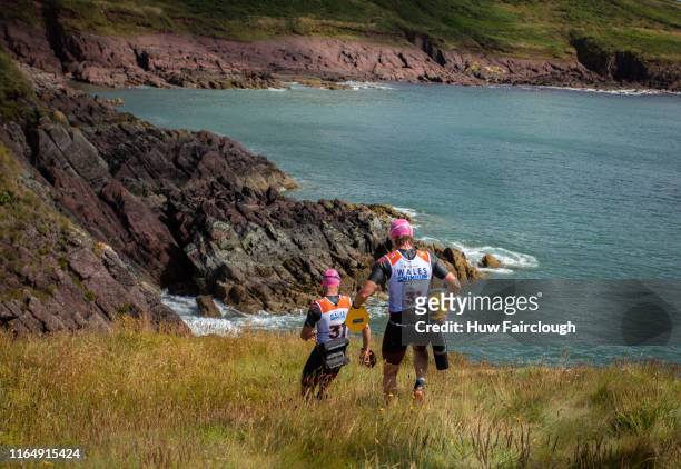 Alexis Charrier and Nicolas Remires descend the cliff to enter the sea during the Wales SwimRun race through Pembrokeshire, starting in Freshwater...